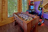 Cabin game room with foosball and pool table