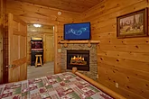 Queen bedroom with fireplace in cabin rental