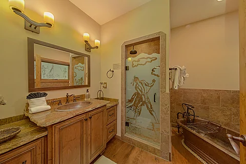 Cabin bathroom with a soaking tub and shower - Grouse Ridge Lodge