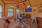 Tiny home cabin with arcade game and fireplace